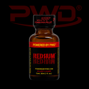 Promotional image of a 30ml bottle of PWD Redrum solvent cleaner with a black and red label, yellow ‘Powered by PWD’ branding, and a black cap featuring PPP Power-Pak Pellet text, displayed against a black background with a large red PWD logo